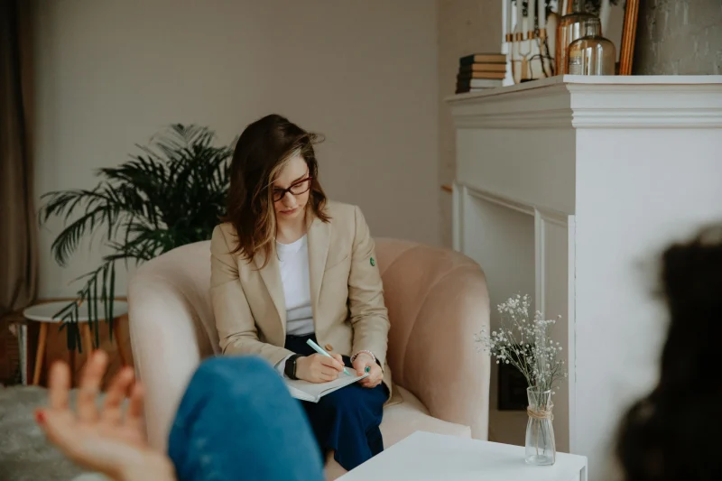 Counsellor taking notes during a counselling session in Basel, Zurich